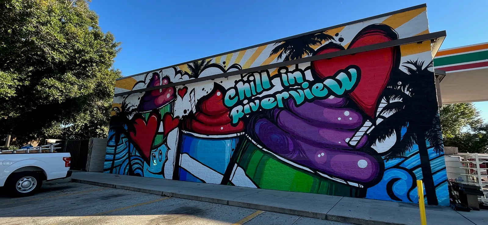 Colorful Chill'n Riverview mural with fruit, palm trees and a bright local-business storefront